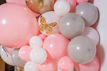 Photo zone with pink balloons and golden butterfly