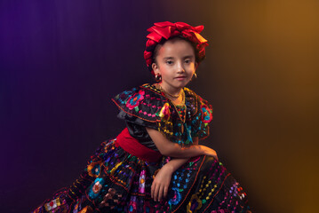 mexican girl with traditional dress from the state of chiapas with a beautiful smile and a black background