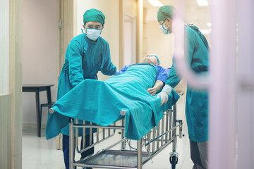 Doctor Getting their patient ready for the next procedure In the corridor, a medical team is...