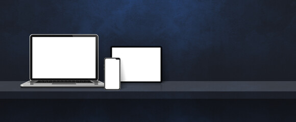 Laptop, mobile phone and digital tablet pc on black wall shelf. Banner background