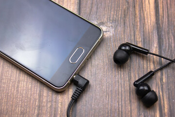 Connecting wired headphones to a smartphone. Headphones and smartphone connector.