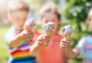 Group of children in the park eating cold ice cream. - Powered by Adobe