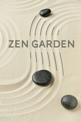 Black stones on sand in zen garden