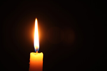 Flame burning candle black background.Concept memory and sorrow.