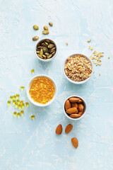 Bowls with pills and healthy products on color background