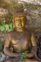 Bronze Buddha statue stay in front of the caves with be adorned at Santacittarama,Rieti,Lazio. Monastery,Buddhist Temple.Ajahn Chah 