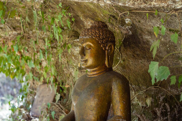 Bronze Buddha statue stay in front of the caves with be adorned at Santacittarama,Rieti,Lazio....