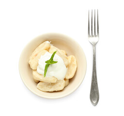 Bowl of delicious lazy dumplings with sour cream and fork on white background