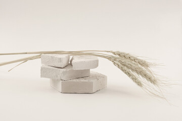 Empty stack of stones platform podium on light beige background. Minimal empty display product presentation scene.