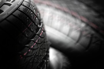 Clean car tyres spinning against dark background
