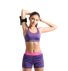 Sporty teenage girl with armband on white background