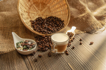 Roasted coffee beans with Espresso on wooden background.