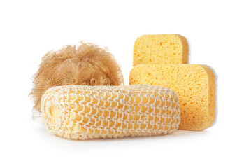 Different bath sponges on white background
