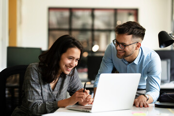 Colleagues in office. Businesswoman and businessman discussing work in office