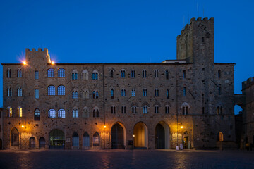Fototapeta premium Pretorio Palace, Porcellino Tower and Priori Square in a quiet moment of the evening with the blue light, Volterra, Pisa, Tuscany, Italy