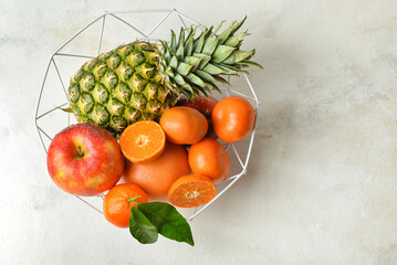 Basket with juicy fruits on white background