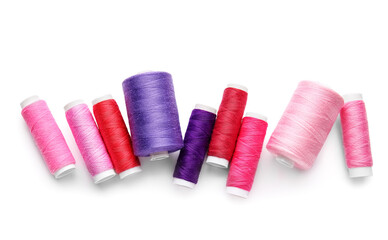 Different thread spools on white background
