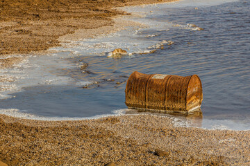 Fototapeta premium Old rusty barrel in saline lake Assal in Djibouti
