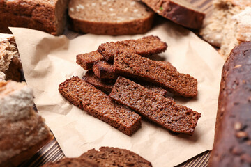 Parchment with tasty croutons on table