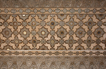 Beautiful design on the wall of  Sheesh Mahal of  ancient Amer fort of Jaipur, India