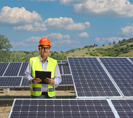 Electrician standing on a solar panel plant