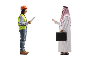 Full length profile shot of an arab businessman talking to a female engineer