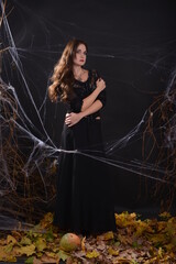 A series of horror-style photos on the web and with candles in hand in a black dress on a black background