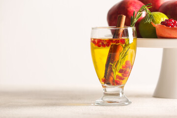 Glass of tasty pomegranate cocktail on white background