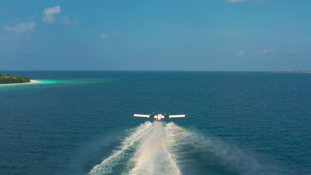 Aerail view on Seaplane taking off in a tropical island in Maldives.