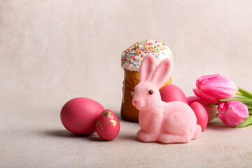 Cute Easter bunny with cake, painted eggs and flowers on pink background