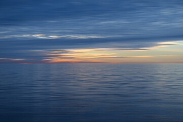 Meditation ocean and sky background. Colorful horizon over the water. Water surface. Abstract cloudscape over the sea, sunrise shot