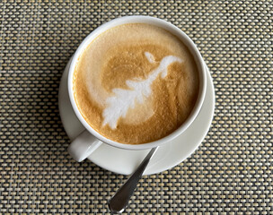 Cappuccino coffee in a cup and saucer 