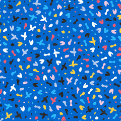 Terrazzo pattern with small colorful shapes on blue background