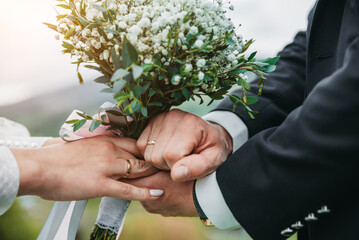 Hands of lovers. Hold hands. Wedding bouquet