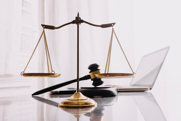Male lawyer working with contract papers and wooden gavel on tabel in courtroom. justice and law...