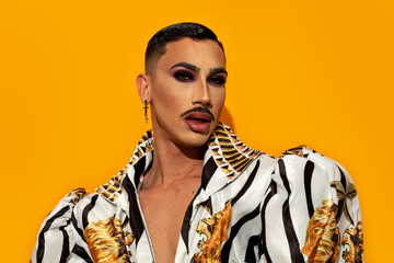 Portrait of beautiful drag queen model with yellow background