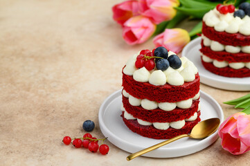Mini red velvet cakes decorated with berries.  Copy space. Selective focus