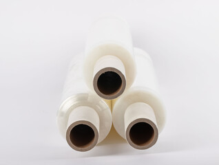 Roll of plastic stretch film with clear wrap. It stands in an isolated environment. It is used in the packaging of products. Overlapping stretch films