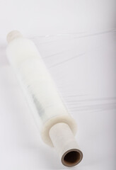 Roll of plastic stretch film with clear wrap. how long the roll of cling film can stretch is shown. It stands in an isolated environment. It is used in the packaging of products.