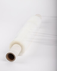 Roll of plastic stretch film with clear wrap. how long the roll of cling film can stretch is shown. It stands in an isolated environment. It is used in the packaging of products.