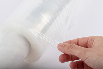 Roll of plastic stretch film with clear wrap. how long the roll of cling film can stretch is shown....