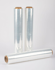 Roll of plastic stretch film with clear wrap. It stands in an isolated environment. It is used in the packaging of products.