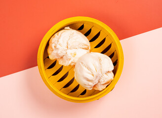 Chinese steamed filled with bbq pork in a wooden dish top view