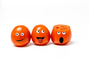 3 cheerful anthropomorphic tomatoes with expressive faces on a white background