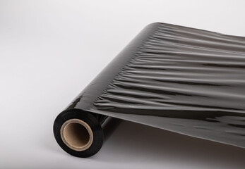 Roll of plastic cling film with black wrap. how long the roll of cling film can stretch is shown. It stands in an isolated environment. It is used in the packaging of products.
