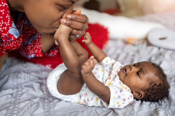 Mother cuddling sleeping baby at home
