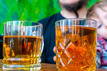 morning family happiness concept. Father and son are drinking tea in the kitchen, painted like a forest. dad and son are having fun.