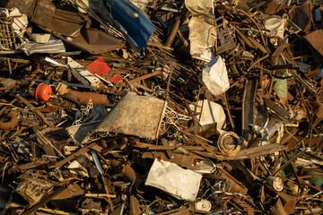Metal scrap background. Heap of scrap metal stored for recycling. Recycling metal waste in warehouse. Grab crane unloads scrap metal in port. Unloading recycle metal waste