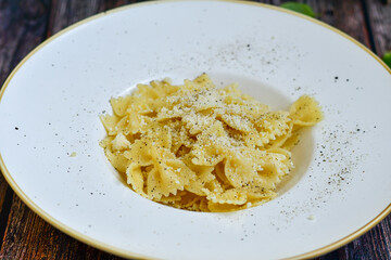 Farfalle Pasta  Cacio e Pepe , olive oil,parmesan cheese, black pepper  and fresh onion. Vegetarian home made Italian pasta

