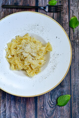 Farfalle Pasta  Cacio e Pepe , olive oil,parmesan cheese, black pepper  and fresh onion. Vegetarian home made Italian pasta
